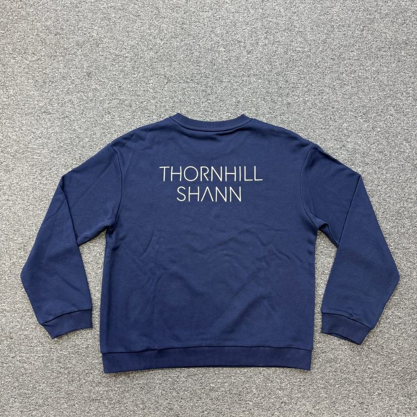 The back of a navy crew sweatshirt with Thornhill Shann across the shoulders