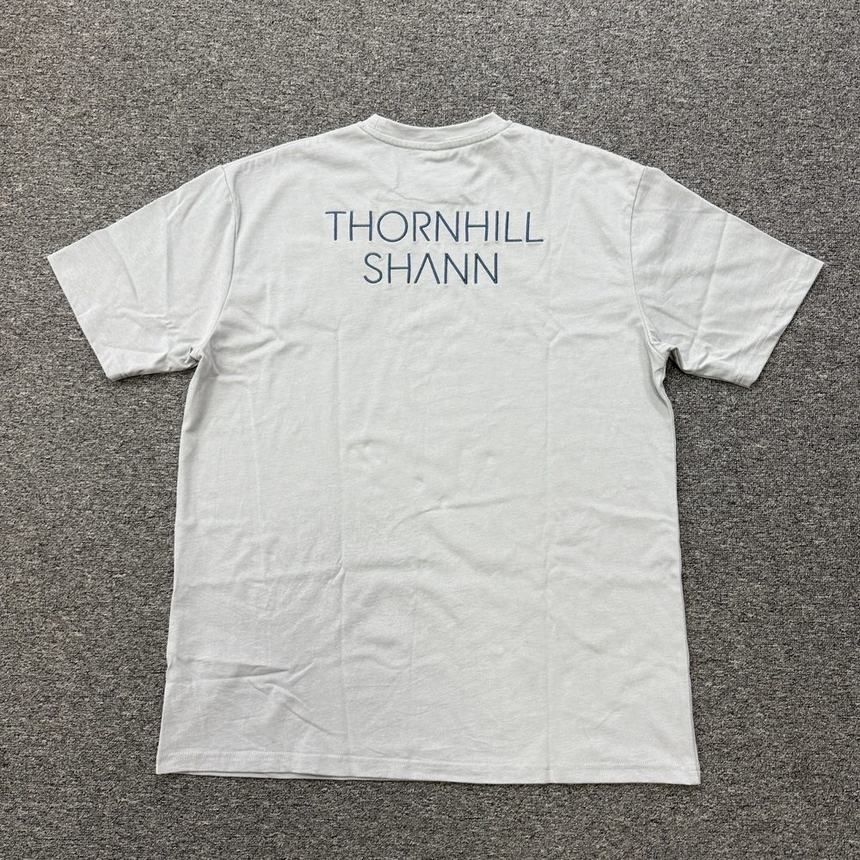 The back of a grey tee with Thornhill Shann across the shoulders